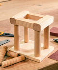 100 Pack Wooden Dowel Pins Kit For DIYers And Furniture Repair In Genuine Imperial Size One Quarter Inch By One And One Sixteenth Inch Fluted Wood Dowels For Woodworking Projects with wooden structure and tools in background