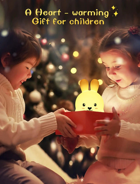 Kids opening a gift with Kids Night Light With Remote, 7 Color Kawaii Cat Nursery Lamp glowing softly, holiday setting.