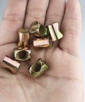 Hand holding 10 Pack Zinc Plated M8 Barrel Nuts 11.5mm Diameter 14.5mm Length For M8x1.25 Bolts Cross Dowels Slotted Nuts
