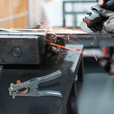 Heavy Duty Welding Ground Clamp For Mig Tig And Mma Welders with copper jaw grip on metal workbench amidst sparks.