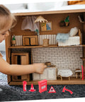 Child playing with Eight Piece Realistic Fire Extinguisher Dollhouse Accessories For Creative Play And Educational Firefighting Scenes