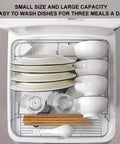 Portable Countertop Dishwasher With Four Wash Cycles And A Slick Bottom Spray Arm Cradles four to five place settings with clean dishes.