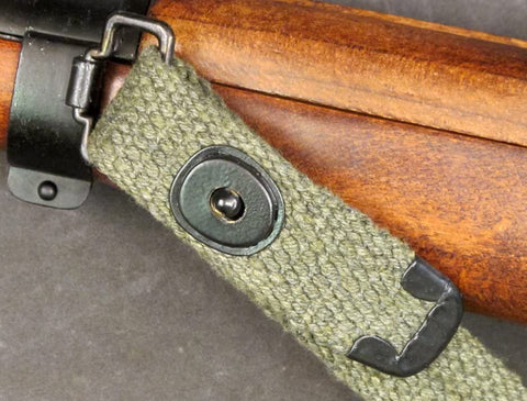 Close-up of M1 Carbine Web Sling OD Green One Inch Canvas Reproduction With Lift-The-Dot Closure attached to rifle.