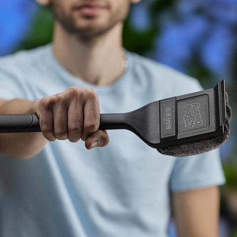 Person holding Steam Activated Grill Brush With ArmorTec Bristle Free Mesh Powered By Scrub Daddy For Quick Beast Mode Grate Cleaning
