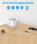 Super Slick Bedside Cube With Four AC Outlets And Three USB Ports ETL Certified Charging Station Power Strip on wooden desk.