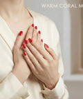 Hands with bright red nails using Semi Cured Gel Nail Strips Real Gel Nail Polish UV Wraps For Brittle Nails Waterproof Long Lasting.