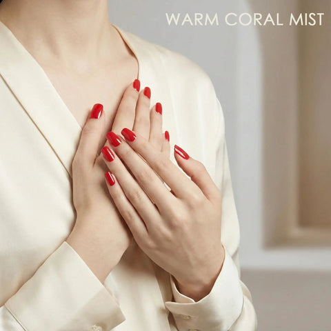 Hands with bright red nails using Semi Cured Gel Nail Strips Real Gel Nail Polish UV Wraps For Brittle Nails Waterproof Long Lasting.