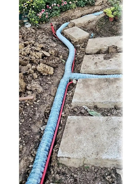 Soft Infiltration Perforated Drainage Pipe For Underground Landscaping And Water Management installed in garden soil with stone path