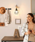 Sturdy Matte Black Wall Mount Coat Rack With Five Heavy Duty Metal Hooks, rustproof, holding coat and hat in a modern entryway.