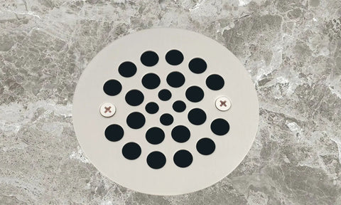 Solid Heavy Duty Shower Strainer Drain Cover With Screw In Trim Set Rust Resistant Brushed Nickel Finish installed on gray flooring.