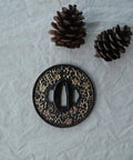 Koshirae Style Samurai Sword With Alloy Tsuba 100 Black And Gold Morning Glory Pattern close-up on tsuba with pinecones