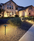 Cast Aluminum Low Voltage Landscape Pathway Lights with Ground Spike and Wire Connectors in garden at dusk