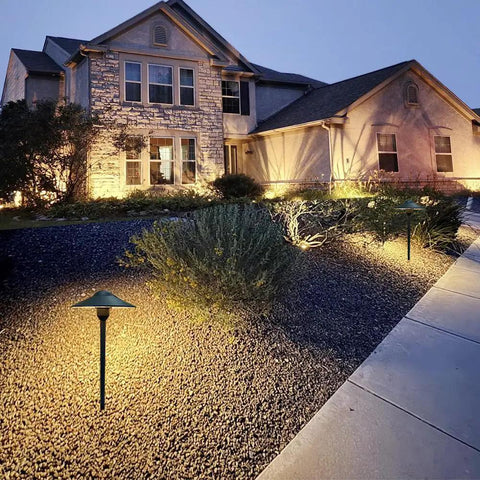 Cast Aluminum Low Voltage Landscape Pathway Lights with Ground Spike and Wire Connectors in garden at dusk