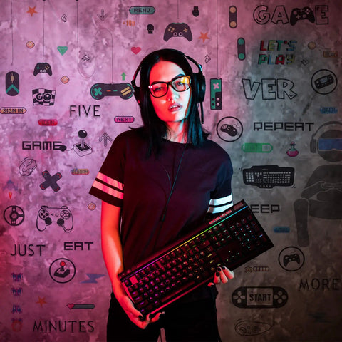 Person holding keyboard in front of wall with White And Black 56 Piece Gamer Wall Decal Set With Controllers And Joysticks
