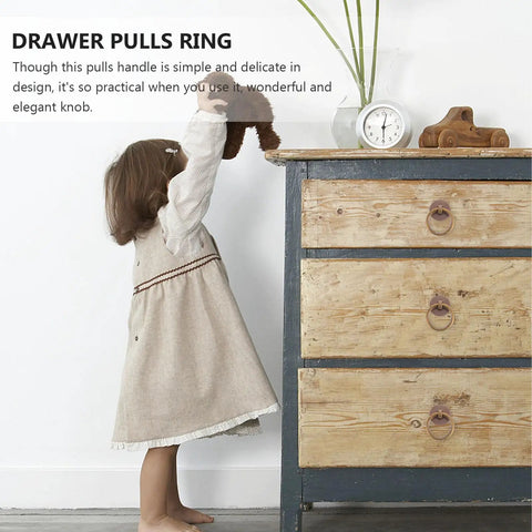 Child reaching for dresser with Retro Style Ring Cabinet Pulls And Drawer Handles In Solid Brass 4cm Antique Bronze Finish Dope