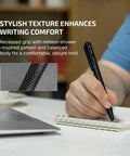 Person using O'Pen 3 EDC Pen Light Go-To 4 in 1 on notebook, showing textured grip and bolt action, next to laptop.