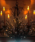Chandelier adorned with Eight Inch Ivory Flameless Taper Candles With Remote And Timer, flickering flame effect and real wax look