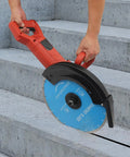 Heavy Duty 14 Inch Circular Concrete Saw With 3000 Watt Electric Motor and Tough As Nails Build for Ripping Through Masonry Machines Featuring Deep Five Point Three One Inch Cutting Depth in use on concrete steps.