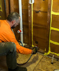 Professional Grade Interior Air Sealant Kicks Drafts To The Curb And Locks Warmth In Along Wall Ceiling Floor Joints Yellow 5 Gallon Big Bucket in use for sealing gaps.