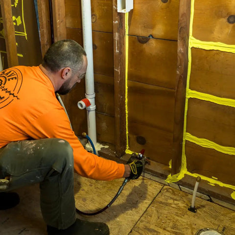 Professional Grade Interior Air Sealant Kicks Drafts To The Curb And Locks Warmth In Along Wall Ceiling Floor Joints Yellow 5 Gallon Big Bucket in use for sealing gaps.