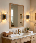 MWZ Modern 2-Light Wall Sconce Set of 2 with Water Rippled Glass Shades 11" illuminating a bathroom vanity with mirror.
