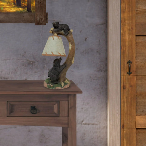 Cozy Cabin Vibes Table Lamp With Hand Painted Tree Climbing Bears on a desk, showcasing wildlife themed woodland decor