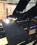 Worker using Plasma Cutter Torch PT 31 Air Plasma Cutting Gun With M161.5 Brass 2 Pin Connectors on metal sheet.