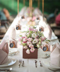 50 Pack Candy Boxes With Compass Gift Sets displayed on wedding table with flowers and rose gold compass theme