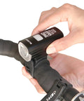 Person installing Ultra Bright Front And Rear USB Rechargeable Bike Light Set for night riding on handlebars.