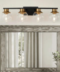 Black Gold 4 Light Vanity Light Fixture Over Mirror With Globe Glass Shades E26 Base Mid Century Modern Wall Sconce in bathroom.