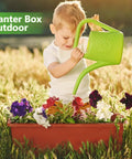 Kick It Up A Notch On Your Deck With These Sturdy Railing Planter Boxes Perfect For Balconies Patios And Windowsills Quick Setup Metal Brackets Included Deep Root Zone For Lush Greenery Classic Red Finish, child watering flowers in red planter box outdoors.