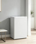 3 Cu Ft Compact Upright Freezer With Reversible Door And Bright White Shell in minimalistic room setting.