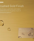 Weymouth Cabinet Or Drawer Pull On 3-Inch Centers In Brushed Gold Finish texture with water droplets showcasing finish quality