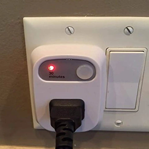 Auto Shut Off Safety Outlet With 30 Minute Timer For Curling Irons And Flat Irons, plugged into wall showing timer.