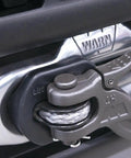 Close-up of AEV Winch Hook Isolator Fairlead Protector Hook Stopper for off-road winching, durable polyurethane, attached to 4WD vehicle.