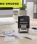 Six Digit Self Inking Numbering Stamp With Crisp Black Ink Marks And Zero Mess Build For Fast Office Workflows That Really Nails The Job Every Single Time on a desk with receipts.