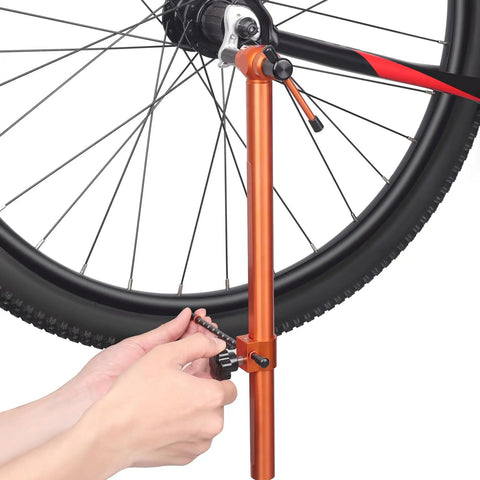 Using Derailleur Hanger Alignment Gauge And Road Bike Dual Control Lever Alignment Tool on bicycle wheel for adjustments.