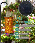 Dragonfly Solar Lantern Outdoor Decor For Patio And Garden, Waterproof Metal Hanging Light with dragonfly motif over flowers.