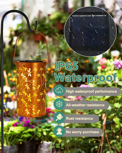 Dragonfly Solar Lantern Outdoor Decor For Patio And Garden, Waterproof Metal Hanging Light with dragonfly motif over flowers.