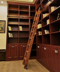 Wooden ladder with Sliding Ladder Hardware Kit For Steel Rolling Ladders With Track And Floor Roller Wheels, Fits 3.3ft To 20ft Systems, rustproof durable track kit installed in a library.