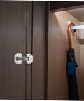 FOYTOKI wardrobe hinge repair kit installed on dark wood cabinet door; white metal hinge plate with screws