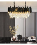 Stylish Black Stainless Steel LED Crystal Pendant Light Dope Design Bright Cold White Hanging Fixture above a modern dining table.