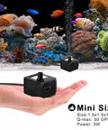 Hand holding Ultra Quiet 50 GPH 3W Mini Submersible Water Pump in front of aquarium setup, highlighting compact size.