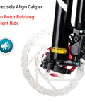 Image showing a close-up of a bike disc brake, highlighting the 4 Pack Bike Disc Brake Pad Replacement Kit With Rotor Alignment Tool and 304 Stainless Steel Spacer Fits All MTB Road BMX Bikes For Easy Gap Regulation And Precise Braking Must Have.