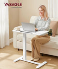 Person using Overbed Table With Wheels Adjustable Height Standing Desk For Home Office Or Hospital Use 27.6 x 15.7 Inch Tabletop Cloud White
