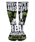 Knee-high socks with landscaper design, text "Everyone's a landscaper until the real landscaper shows up," green and black print.