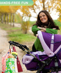 Woman smiling with stroller and Go To Hands Free Stroller Hooks For Bags, 2 Pack Non Slip Clips holding bags on a walk