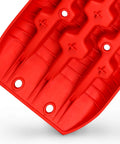 Close-up of red Recovery Traction Tracks for 4WD SUVs and Trucks, Mud Sand Snow Off Road Mats, Ladder Style Tire Ladder Kit