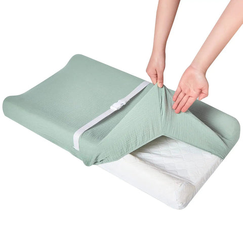 Ultra Soft Muslin Changing Pad Cover For Baby Diaper Changes Fits 32x16 To 34x16 Standard Pads, Cozy And Breathable, being fitted onto a pad