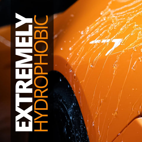 Close-up of water beading on a car hood, text reading 'Extremely Hydrophobic'. Feature of Platinum Rapid Ceramic Paint Sealant Spray 14 Oz With 50 Wash Rating For Boss Gloss And Shine, Sick Hydrophobic Beading And Slickness, Long Lasting Ceramic Coating For Showroom Shine.